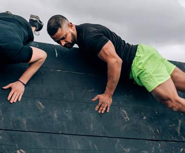 A man climbing down an obstacle.